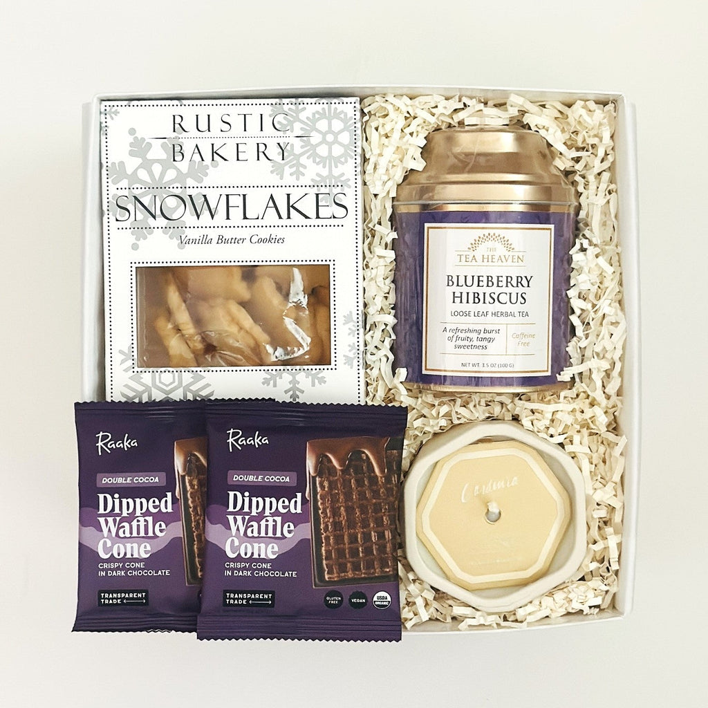 Gift set with cookies, tea, and candles on a white background