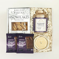Gift set with cookies, tea, and candles on a white background